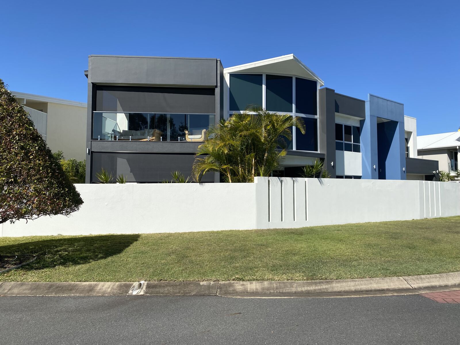 Outdoor blinds on the balcony of a modern two-storey home