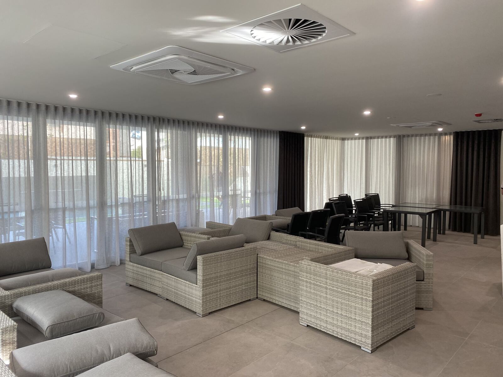 Sheer and blockout curtains in a large open living area