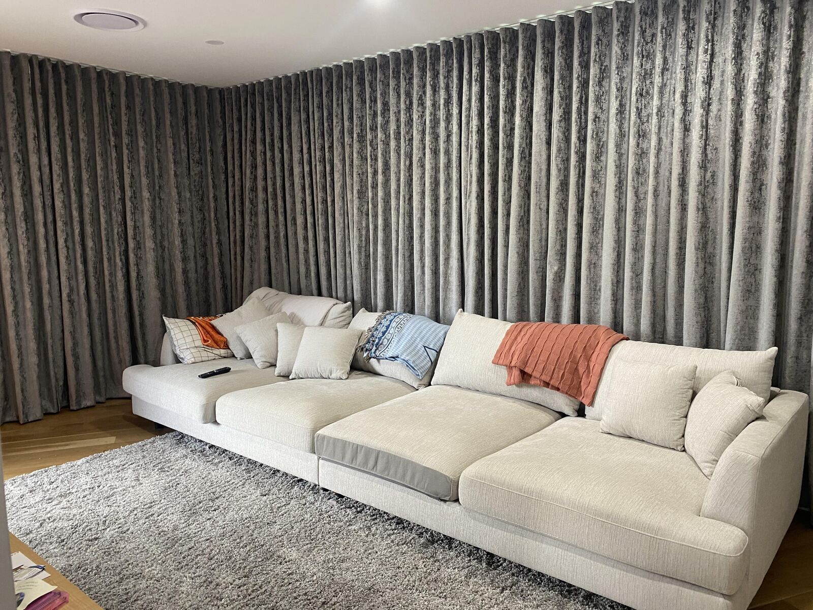 Patterned grey wave fold curtains behind a lounge