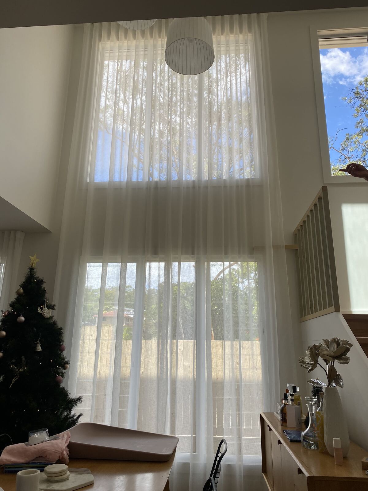 Extra-tall sheer curtains on double-height windows